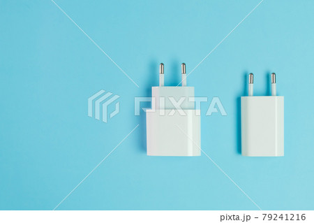 Adapters for charging smartphone with usb type c and a connector on the blue background Adapters for charging smartphone with usb type c and a connector on the blue background 79241216