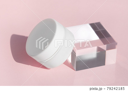 Luxury face cream cosmetic mock up on transparent solid block. Blank jar of organic lotion, medical balm standing on glass cube podium pedestal showcase. 79242185