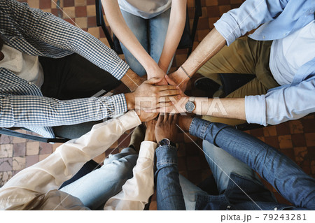 Top view of diverse people hands holding together in circle, hands stack Top view of diverse people hands holding together in circle, hands stack 79243281