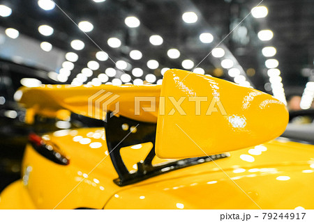 Yellow racing spoiler on the car Close-up. The concept of a sports car. Yellow racing spoiler on the car Close-up. The concept of a sports car. 79244917