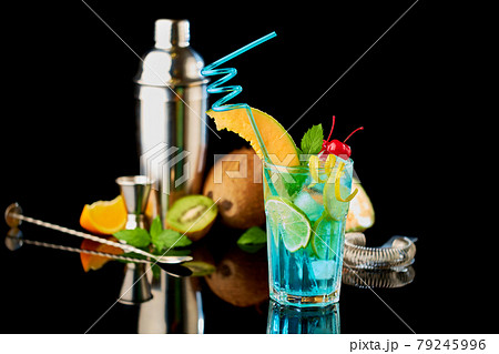 Blue Lagoon cocktail with a slice of melon and cherry isolated on white Blue Lagoon cocktail with a slice of melon and cherry isolated on white 79245996