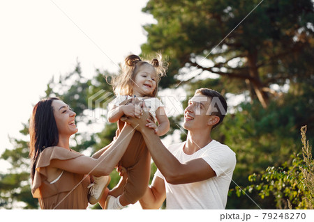 Cute family playing in a autumn field Cute family playing in a autumn field 79248270