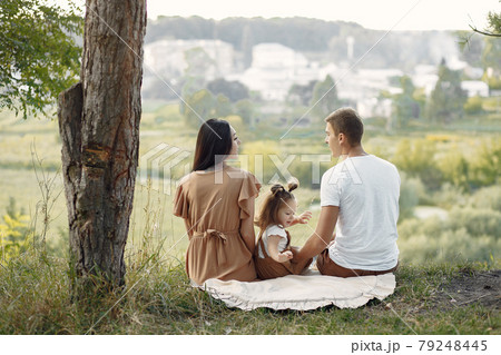 Cute family playing in a autumn field 79248445