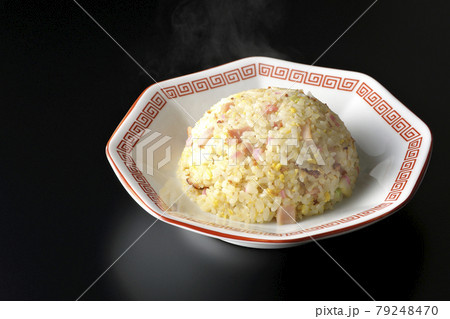 鳴門巻きやチャーシューなど色々な具材が入った熱々の五目チャーハンを黒背景で撮影 79248470