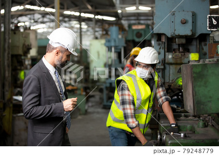 Engineer manager and Factory Workers Team checking machine in production line. Teamwork concept. Engineer manager and Factory Workers Team checking machine in production line. Teamwork concept. 79248779