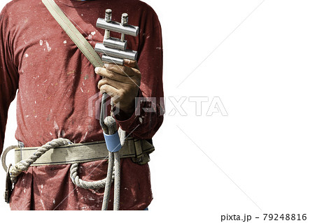 Closeup construction workers hand holding steel hooks connecting with rope safety device equipment. 79248816