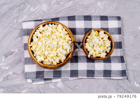 Popcorn on gray cement background. Cinema concept image. loft wall background. Watch movies online. Popcorn on gray cement background. Cinema concept image. loft wall background. Watch movies online. 79249176