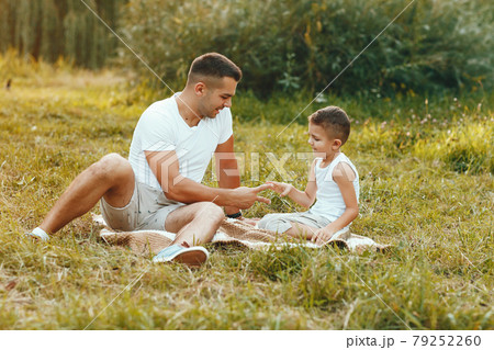 Cute family playing in a summer field 79252260