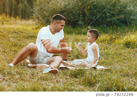 Cute family playing in a summer field Cute family playing in a summer field 79252266