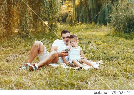 Cute family playing in a summer field Cute family playing in a summer field 79252276