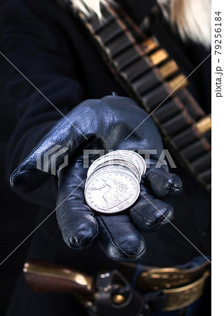 wild west blonde girl with silver dollars in hand and gun wild west blonde girl with silver dollars in hand and gun 79256184
