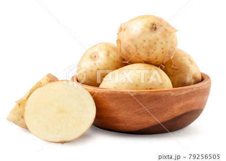 Young unpeeled potatoes whole and half in a wooden plate on a white background. Isolated Young unpeeled potatoes whole and half in a wooden plate on a white background. Isolated 79256505