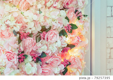 Many artificial pink and white roses are decorated on the glass door to the backdrop in the afternoon. Beautiful flowers background, Selective focus. Many artificial pink and white roses are decorated on the glass door to the backdrop in the afternoon. Beautiful flowers background, Selective focus. 79257395