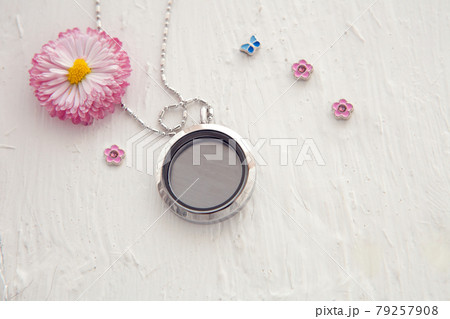 Silver necklace for her shining on white with pink flowers. Luxury silver jewelry chains with glass and crystals. Small Beautiful precious metal present for woman. Luxury expressions 79257908