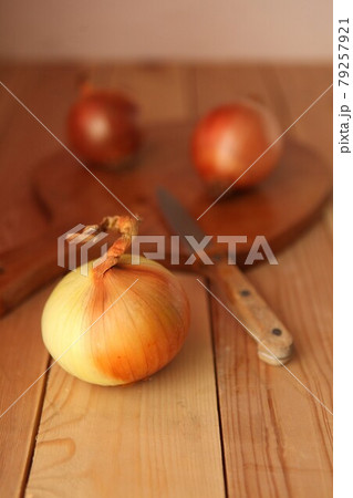 Onion and slices on wooden cutting board. onions at the wooden table Onion and slices on wooden cutting board. onions at the wooden table 79257921