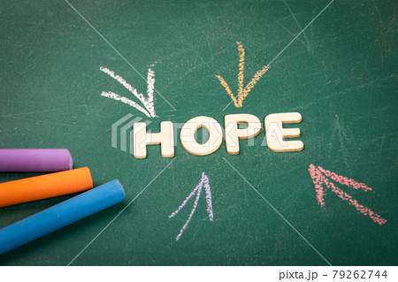 HOPE. Wooden alphabet letters on a green blackboard background HOPE. Wooden alphabet letters on a green blackboard background 79262744
