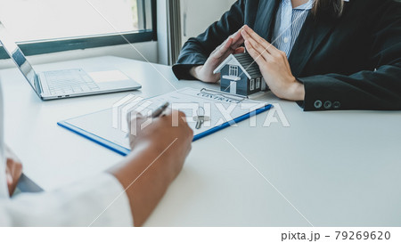 Hand real estate agent prevent home model, buyer signing on contract after the explains the business contract, rent, purchase, mortgage, loan, or home insurance Hand real estate agent prevent home model, buyer signing on contract after the explains the business contract, rent, purchase, mortgage, loan, or home insurance 79269620