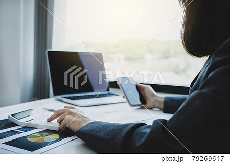 Businesswomen bookkeeper hand use calculator and laptop doing account for paying tax on white desk in working office 79269647