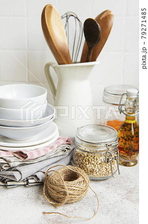 Kitchen utensils, tools and dishware on on the background white tile wall. Kitchen utensils, tools and dishware on on the background white tile wall. 79271485