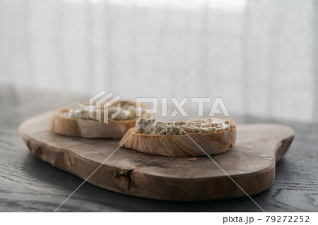 Ciabatta slices with cream cheese and herbs on olive wood board Ciabatta slices with cream cheese and herbs on olive wood board 79272252
