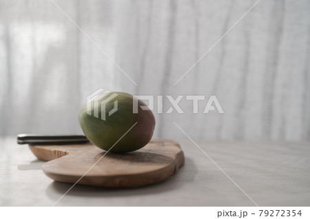 Ripe green mango on olive wood board 79272354