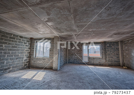 Apartment interior without finishing. Room in new building without repair, walls are not plastered. Repair works on construction site of residential apartment. 79273437