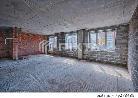 Apartment interior without finishing. Room in new building without repair, walls are not plastered. Repair works on construction site of residential apartment. Apartment interior without finishing. Room in new building without repair, walls are not plastered. Repair works on construction site of residential apartment. 79273439