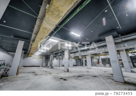 Construction of spacious well-lit underground car park with parking spaces. Empty parking garage underground, industrial interior Construction of spacious well-lit underground car park with parking spaces. Empty parking garage underground, industrial interior 79273455