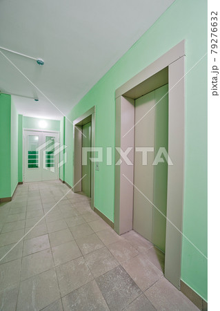 Elevator in an apartment building interior with green walls. Hallway in new building with repair. Repair works on construction site of residential apartments. 79276632