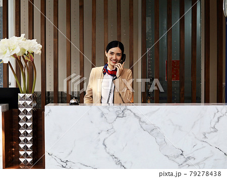 Asia reception woman smile portrait in reception area at hotel. Asia reception woman smile portrait in reception area at hotel. 79278438
