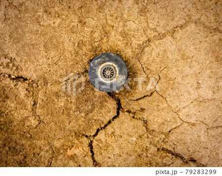 Sprinkler head on dry soil top view. Drought, water lack in arid climat affecting life of millions people all around the word 79283299