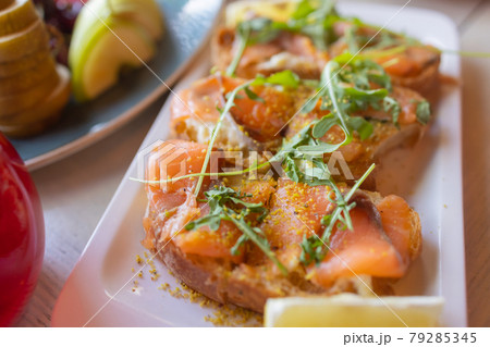 Dinner table with snacks decorated with beautiful summer flowers. Food Table Healthy Delicious Organic Meal Concept. Waiting for the guest. Dinner table with snacks decorated with beautiful summer flowers. Food Table Healthy Delicious Organic Meal Concept. Waiting for the guest. 79285345