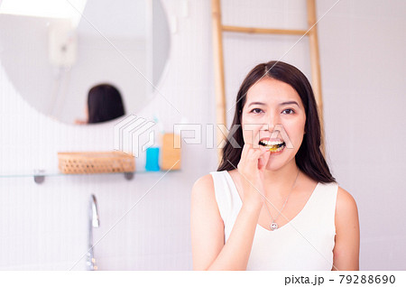 Asian woman putting braces teeth or silicone trainer,Orthodontic,Dental health concept,Decayed tooth 79288690