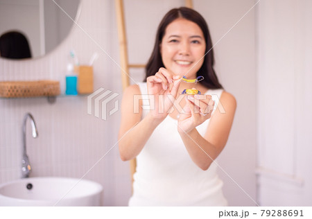 Woman holding braces teeth or silicone trainer,Orthodontic,Dental health concept,Decayed tooth 79288691