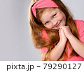 Portrait of cute, sly smiling redhead kid girl 79290127