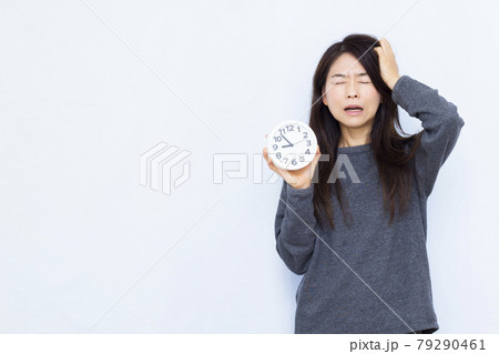 寝坊をしてびっくりしている30代の女性 寝坊をしてびっくりしている30代の女性 79290461