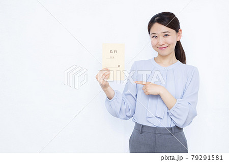 笑顔で給料袋を持つ30代のビジネスウーマン 笑顔で給料袋を持つ30代のビジネスウーマン 79291581