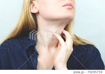 Woman have a sore throat. Female touching neck with hand. Healthcare Concepts 79295759