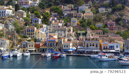 Greece. Dodecanese. Islands Symi.Colorful houses and boats and yachts . 79296523