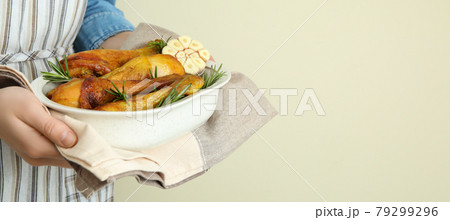 Woman hold baking tray with roast chicken drumsticks Woman hold baking tray with roast chicken drumsticks 79299296