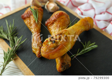 Board with roast chicken drumsticks, close up Board with roast chicken drumsticks, close up 79299300