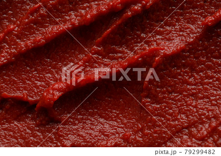 Tasty tomato paste on whole background, close up Tasty tomato paste on whole background, close up 79299482