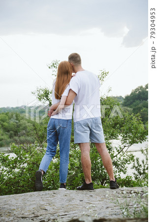 Budget-Friendly Honeymoon Destinations, Romantic getaway, solo couple travel. Couple in love, newlyweds in white t-shirt having fun on nature background. Young couple enjoying in local travel 79304953