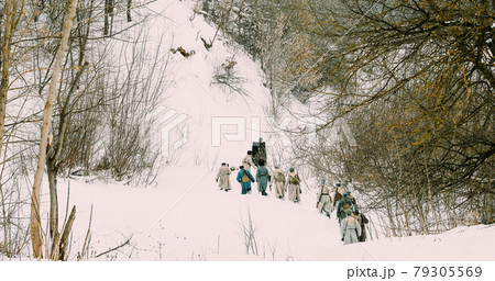 Men Dressed As White Guard Soldiers Of Imperial Russian Army In Russian Civil War Times Marching Through Snowy Winter Forest. Historical Reenactment 1917-1922. 79305569