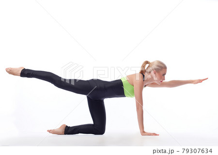 Attractive female gymnast exercising at studio 79307634