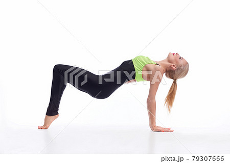 Attractive female gymnast exercising at studio Attractive female gymnast exercising at studio 79307666