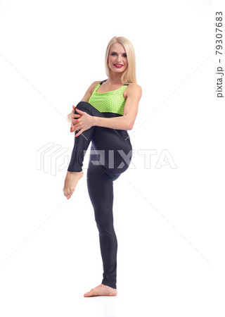 Attractive female gymnast exercising at studio Attractive female gymnast exercising at studio 79307683
