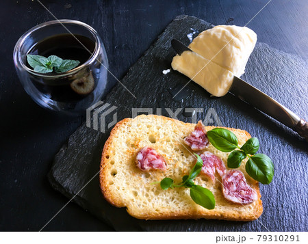 A delicious and hearty classic breakfast. Fresh coffee with mint leaf, young basil leaves and the freshest mozzarella 79310291