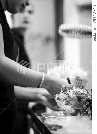 staff making italian gelato ice cream sundae in modern shop 79312315