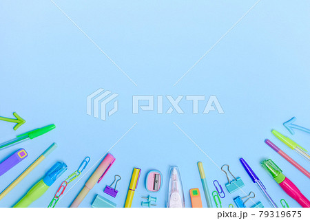 Frame of different stationery items on blue background with copy space. Frame of different stationery items on blue background with copy space. 79319675